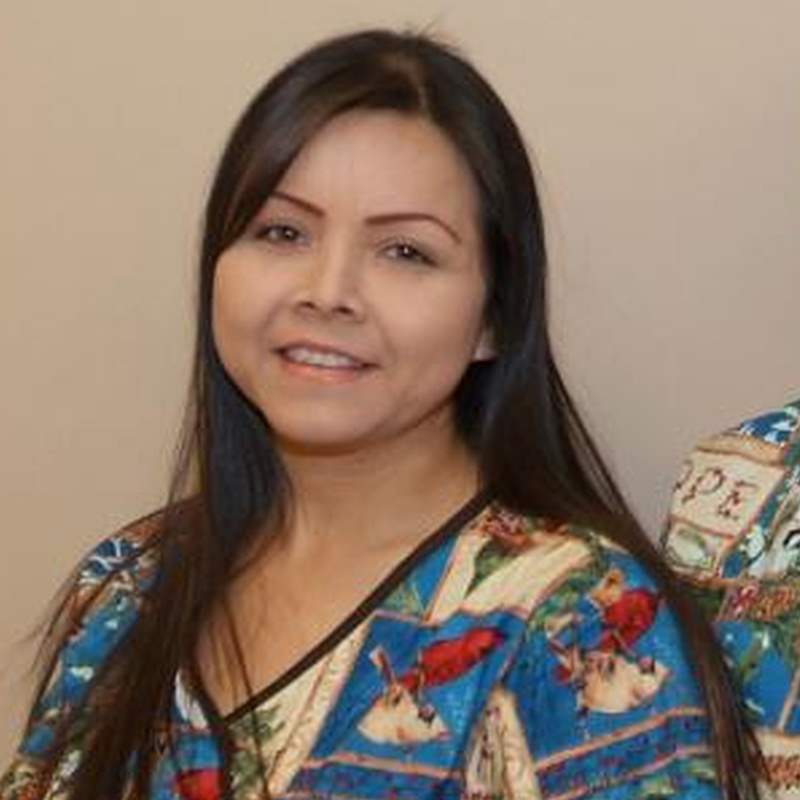 Smiling woman in blue patterned top